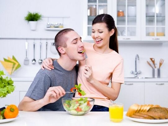 a woman feeds a man with products to increase potency naturally
